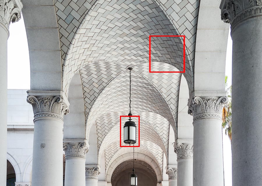 The arcade at Los Angeles City Hall, with red boxes marking a hanging lantern and the patterned tile ceiling.